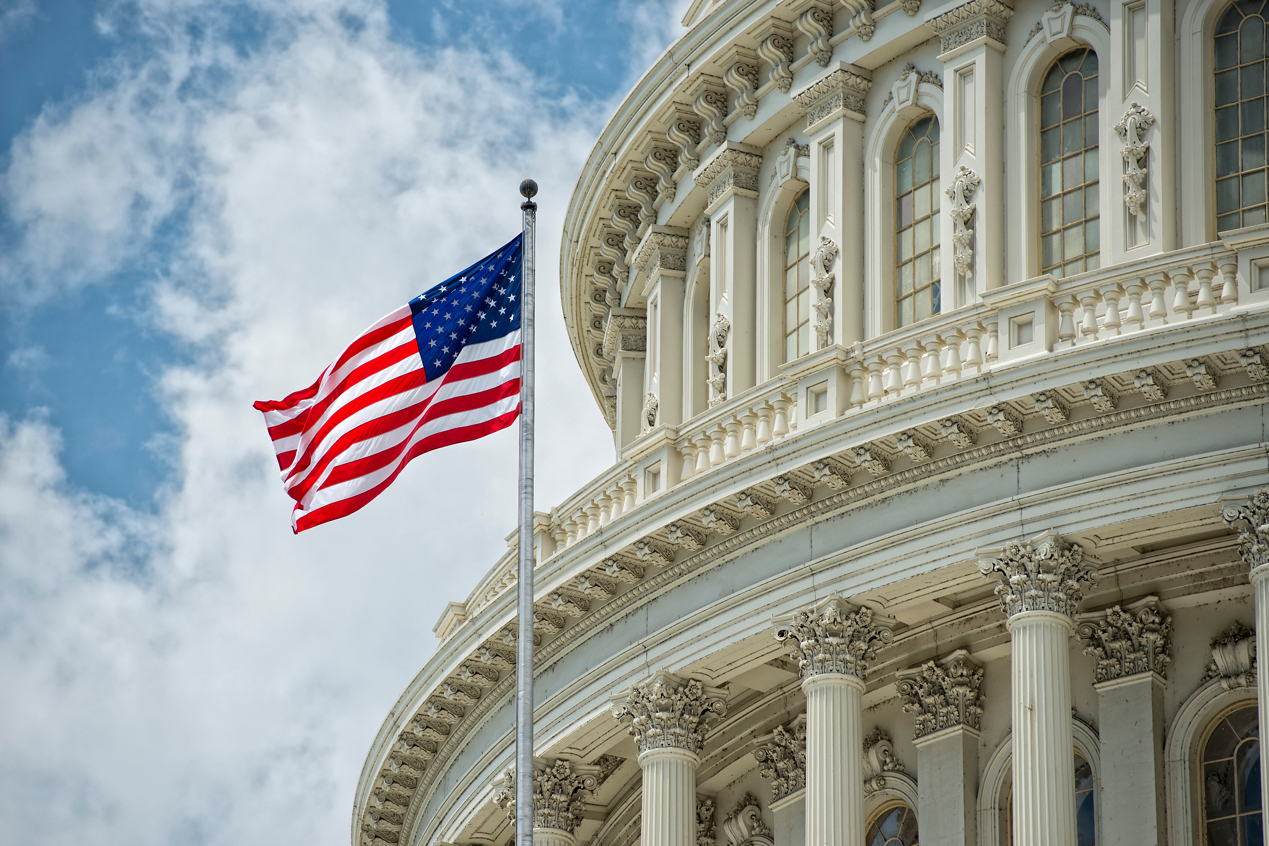 Washington D.C. Capitol dome detail with waving American flag