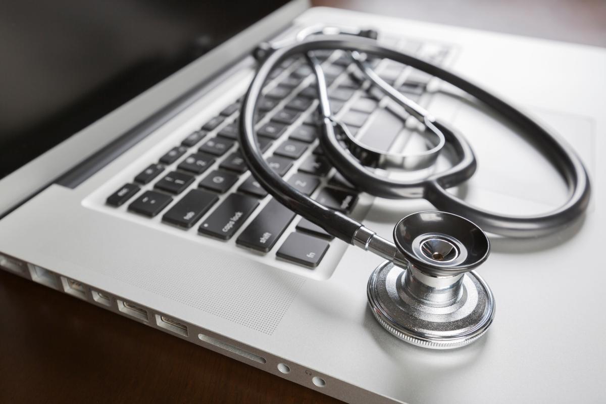 A stethoscope on top of a laptop's keyboard