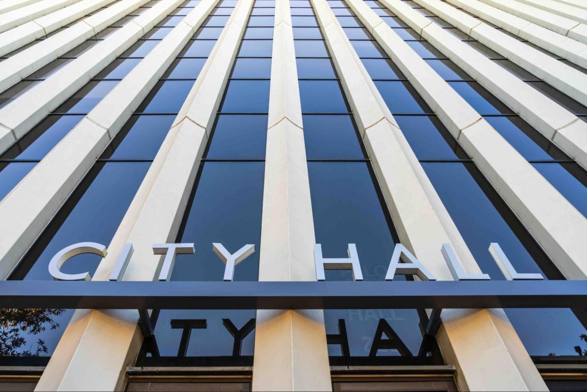 Photo of a modern building with the words "City Hall" at its entrance