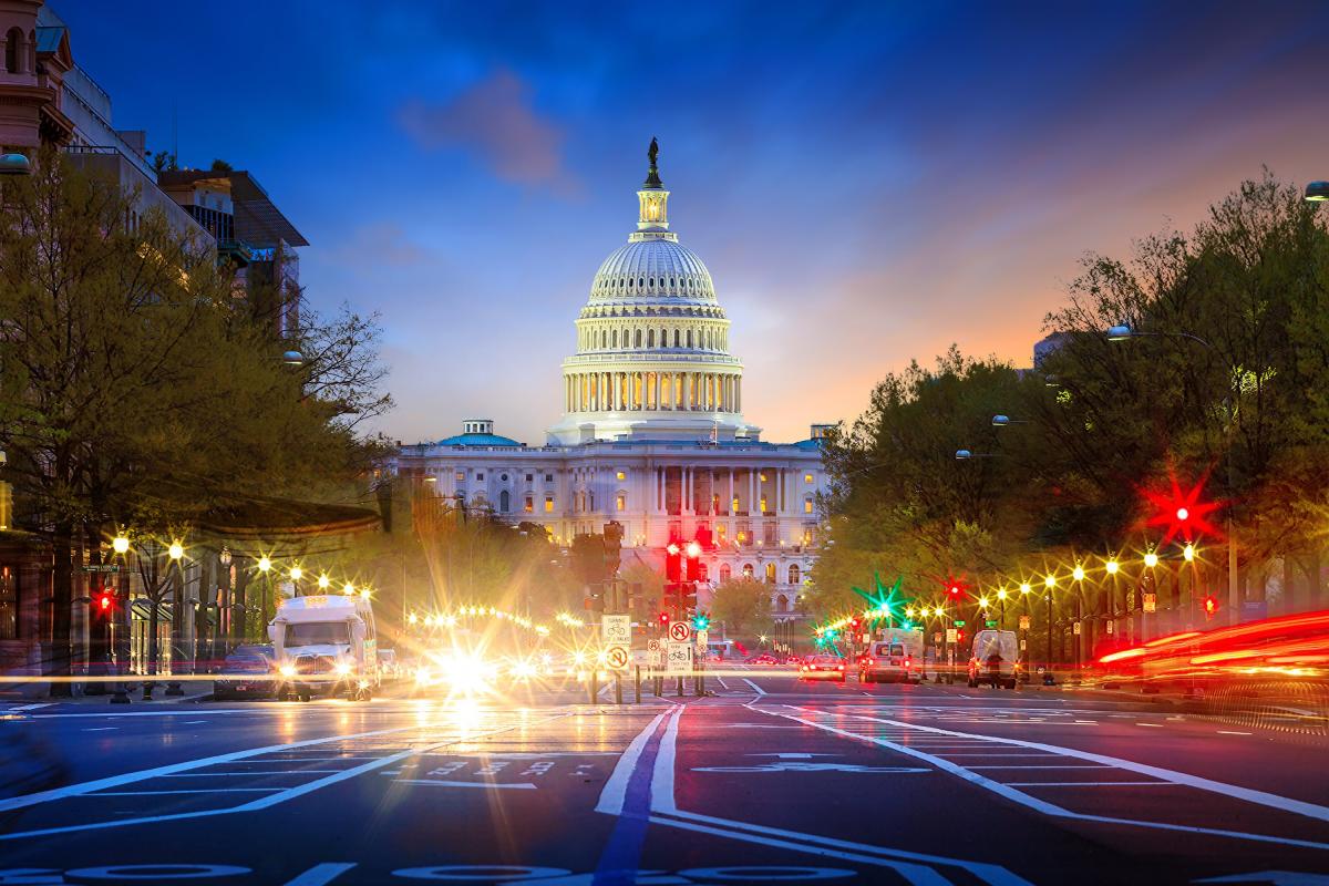 Photo of a Washington DC street with the Capitol building in the background at sunset