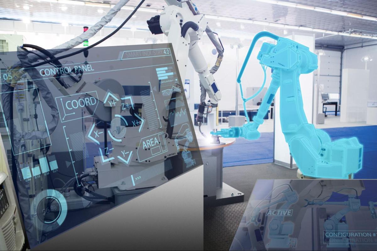 Robotic industrial arm in front of computer monitor